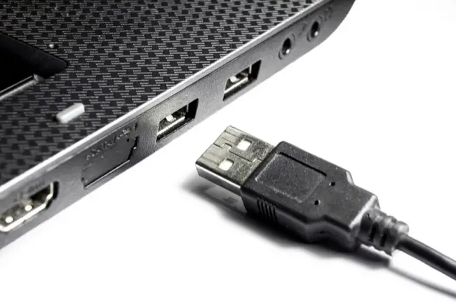 Laptop with USB connectors and USB cable on a white background close-up